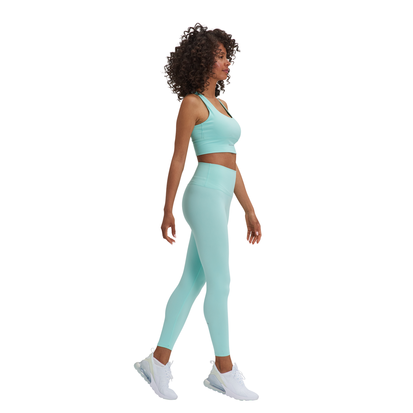 A woman in a blue Kulture sports bra top and Soho Sculpt leggings.