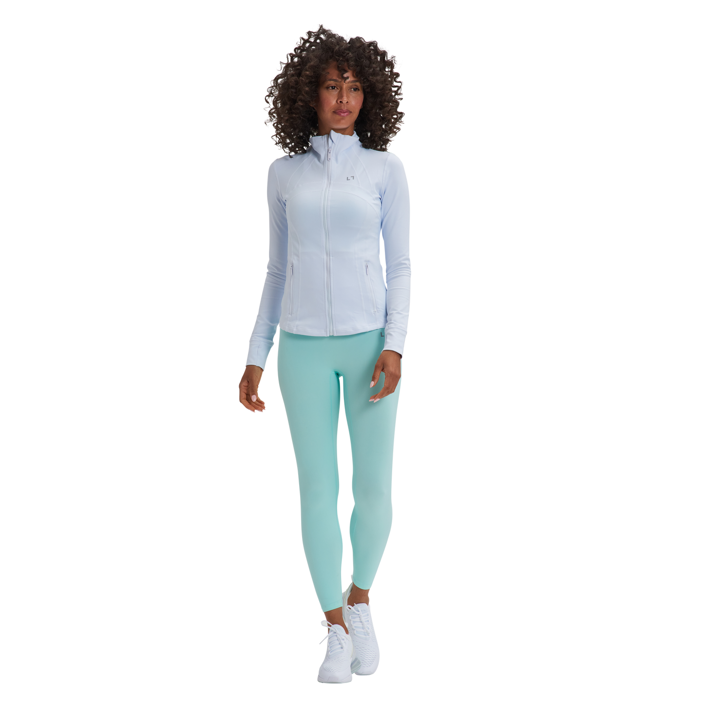 A woman in a white shirt and mint green Kulture Sunset Define Full-Zip Jacket with Pockets leggings.
