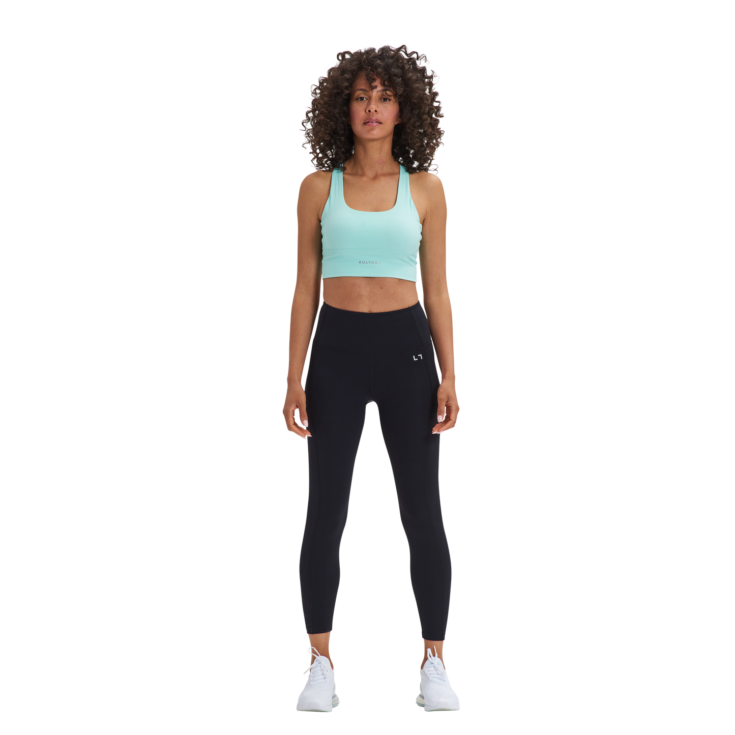 A woman in a Kulture Weho Control Sports Bra top and leggings.
