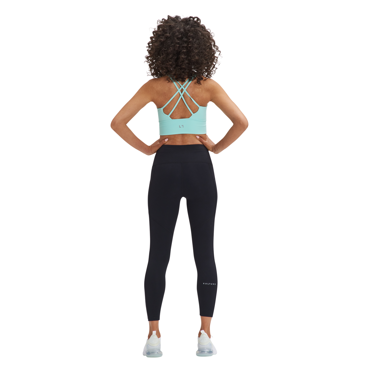 A woman in a Kulture Weho Control Sports Bra top and leggings.