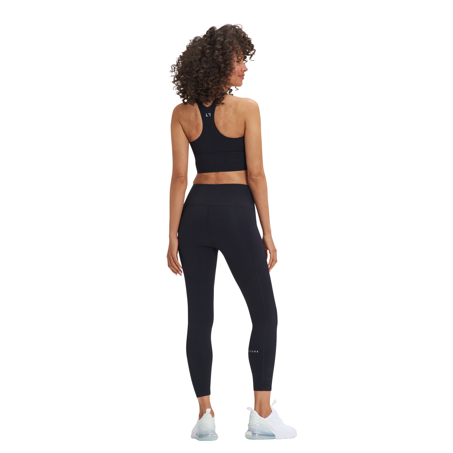 A woman in Kulture's Weho Train Sports Bra top and leggings.