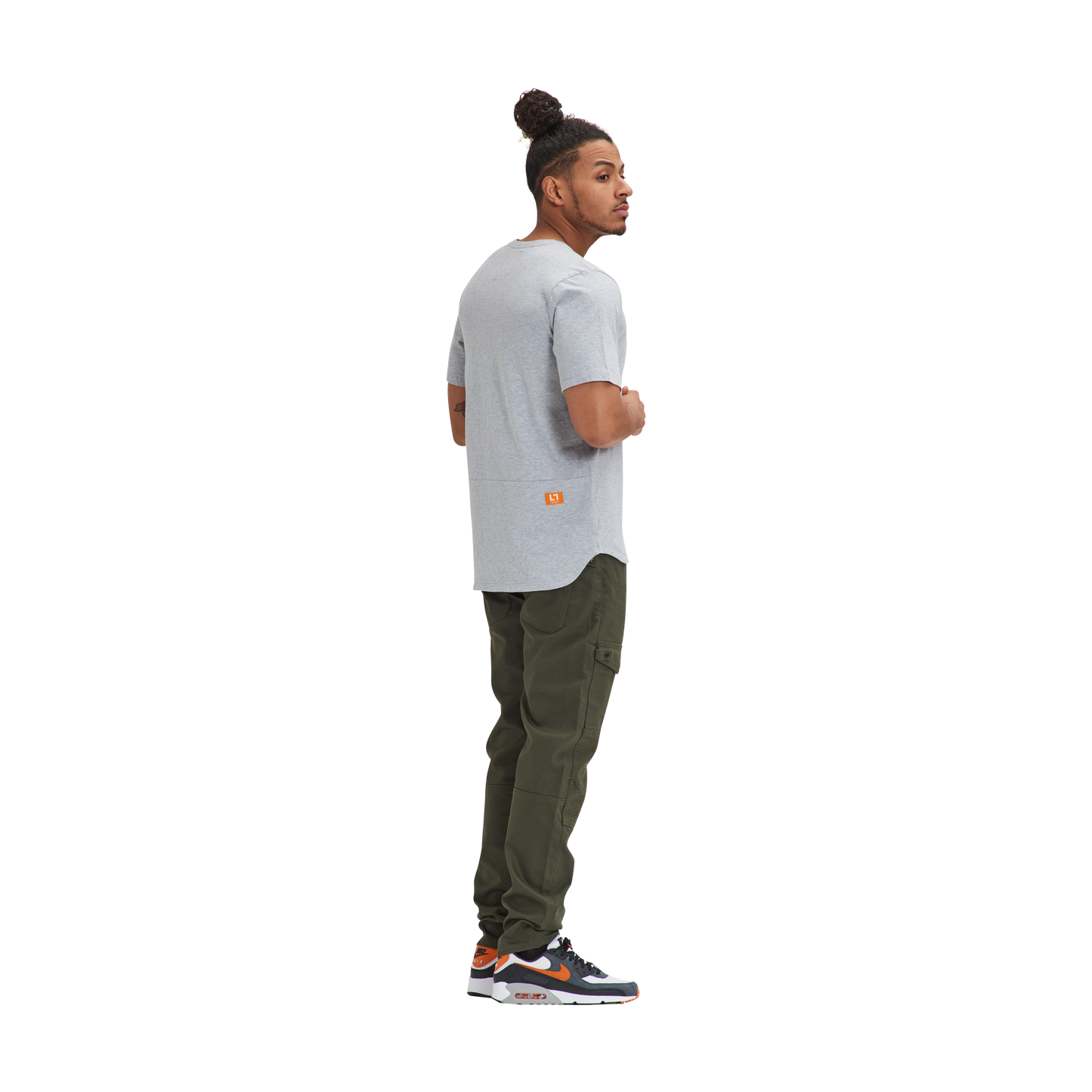 A man wearing a Kulture MIA Drop Cut Tee (3) PK Black / Charcoal / Heather and green pants.