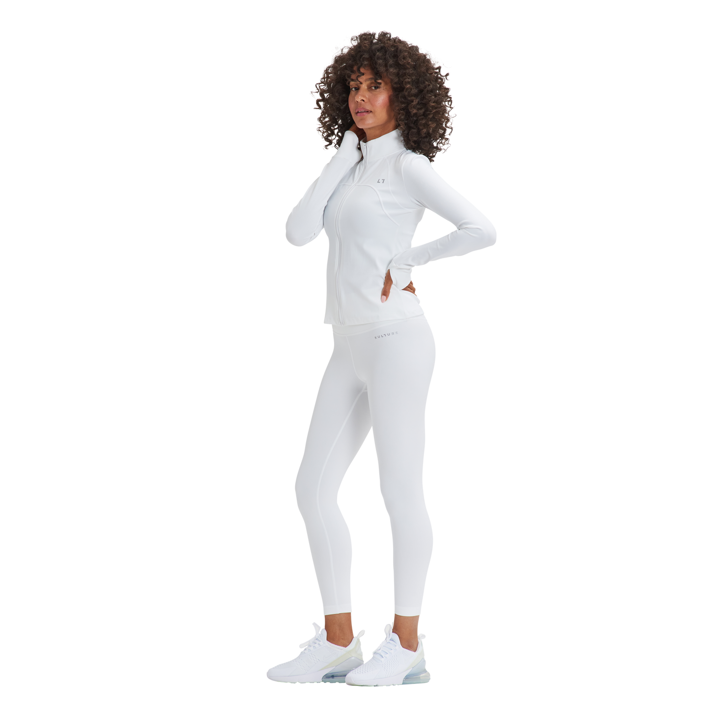 A woman in white Kulture Soho Sculpt Leggings is posing for a picture.