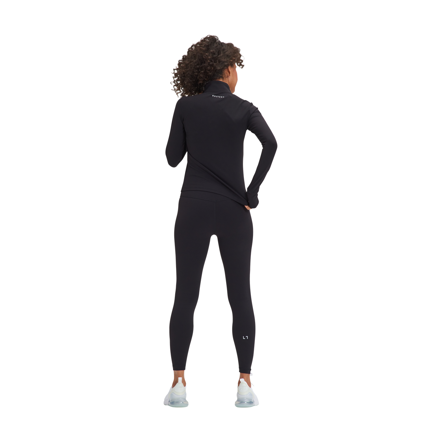 A woman wearing a Kulture Marina Sculpt Yoga Jacket wetsuit and white shoes.