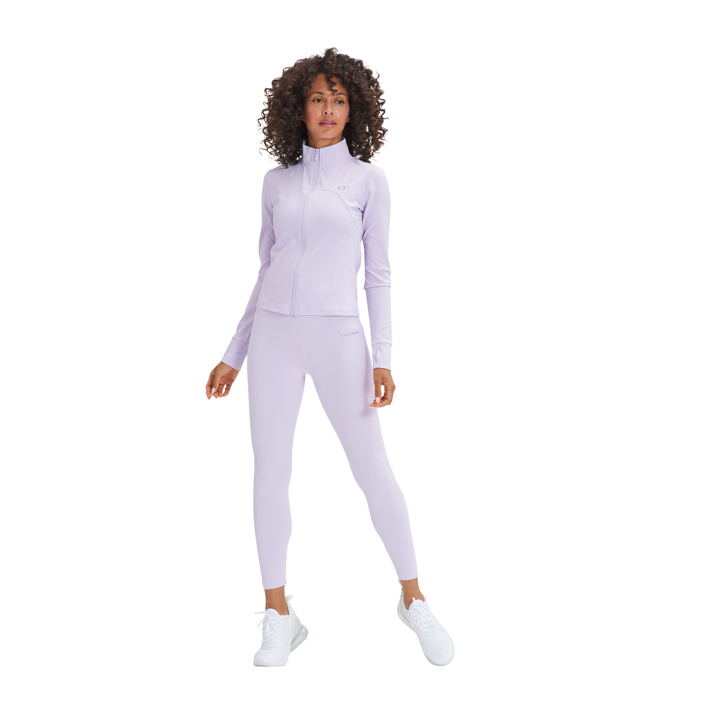 A woman in a purple top and Kulture's Soho Sculpt Leggings.