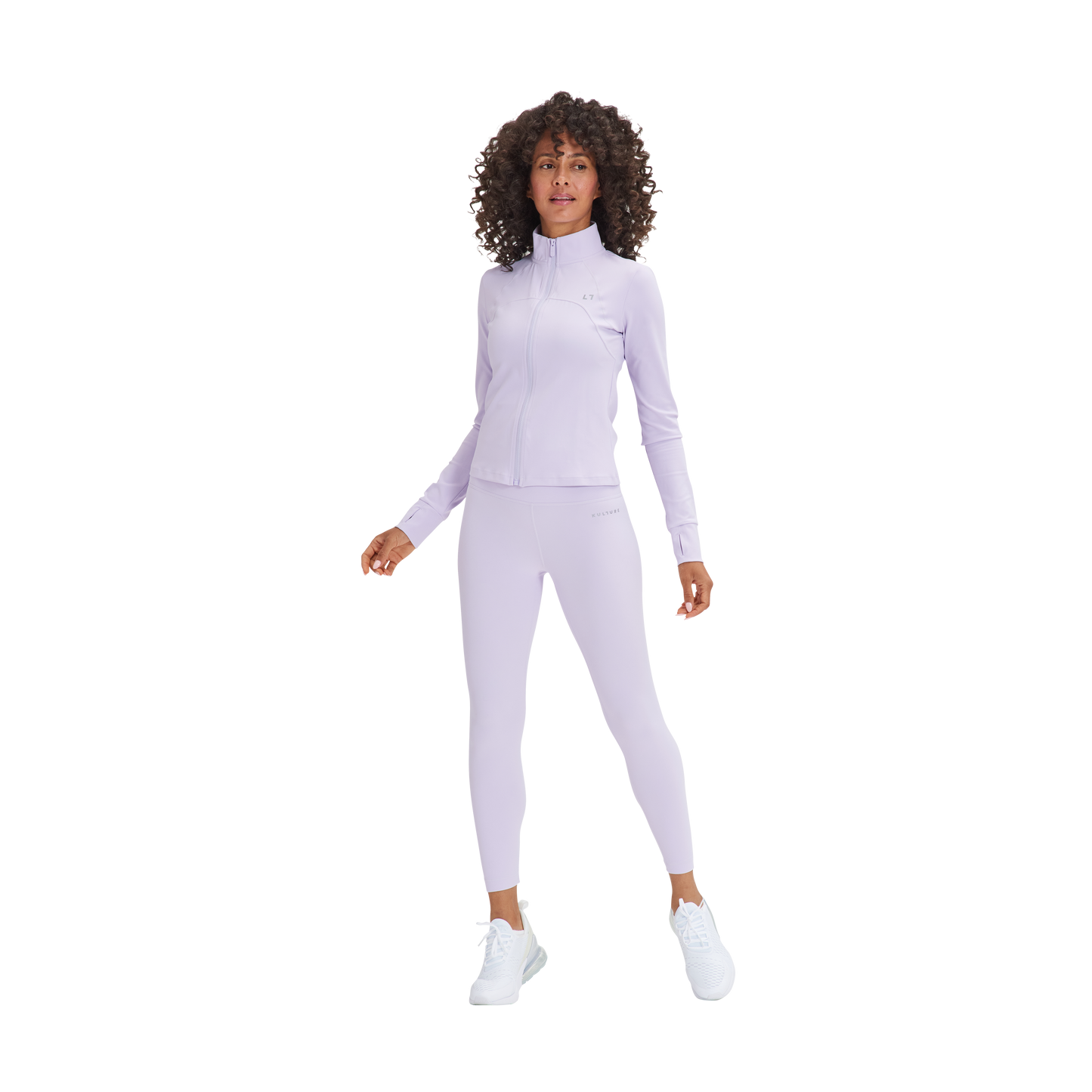 A woman in a Kulture Marina Sculpt Yoga Jacket and purple pants.
