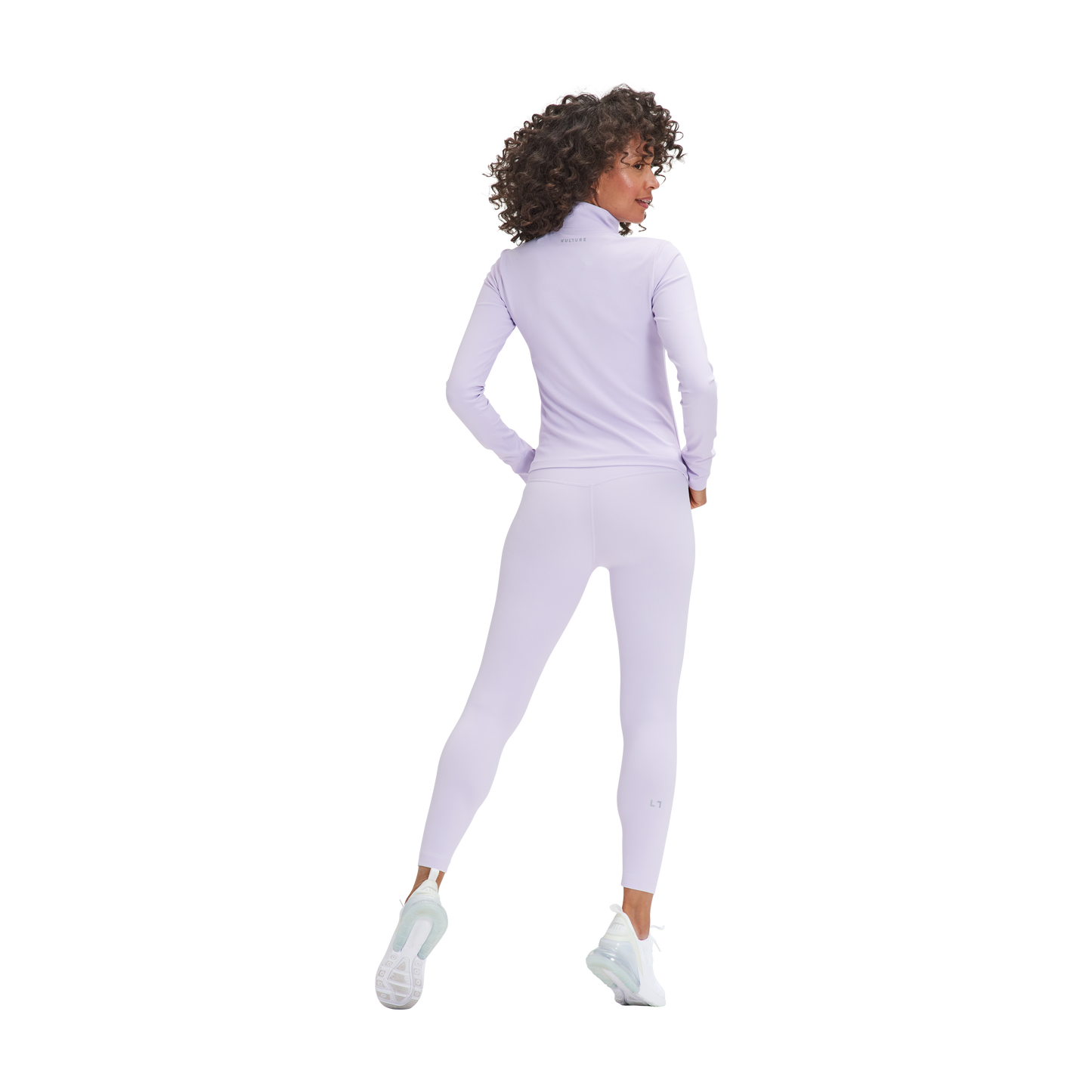 A woman in a Kulture Marina Sculpt Yoga Jacket and leggings.