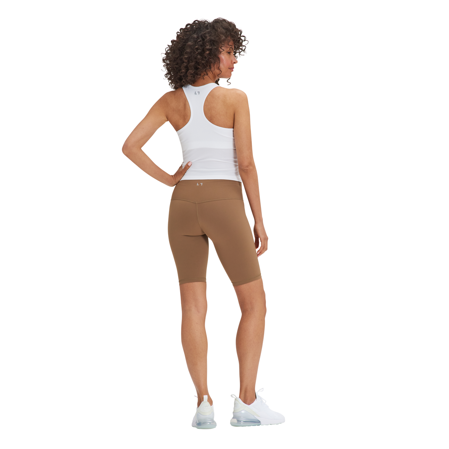 A woman in a Kulture Noho Seamless Built-In Bra Tank Top and brown shorts.