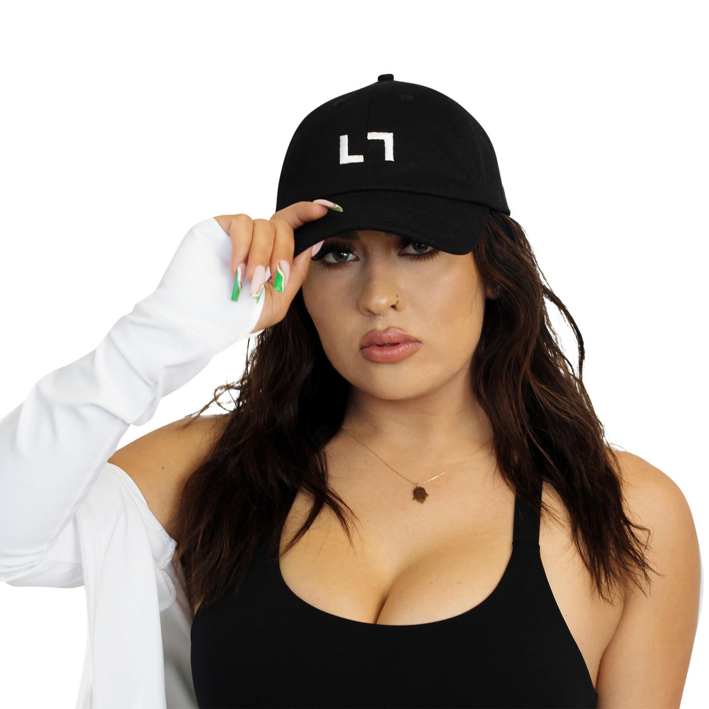 A woman wearing a black PHX Kulture Dad Hat with the letter l on it.