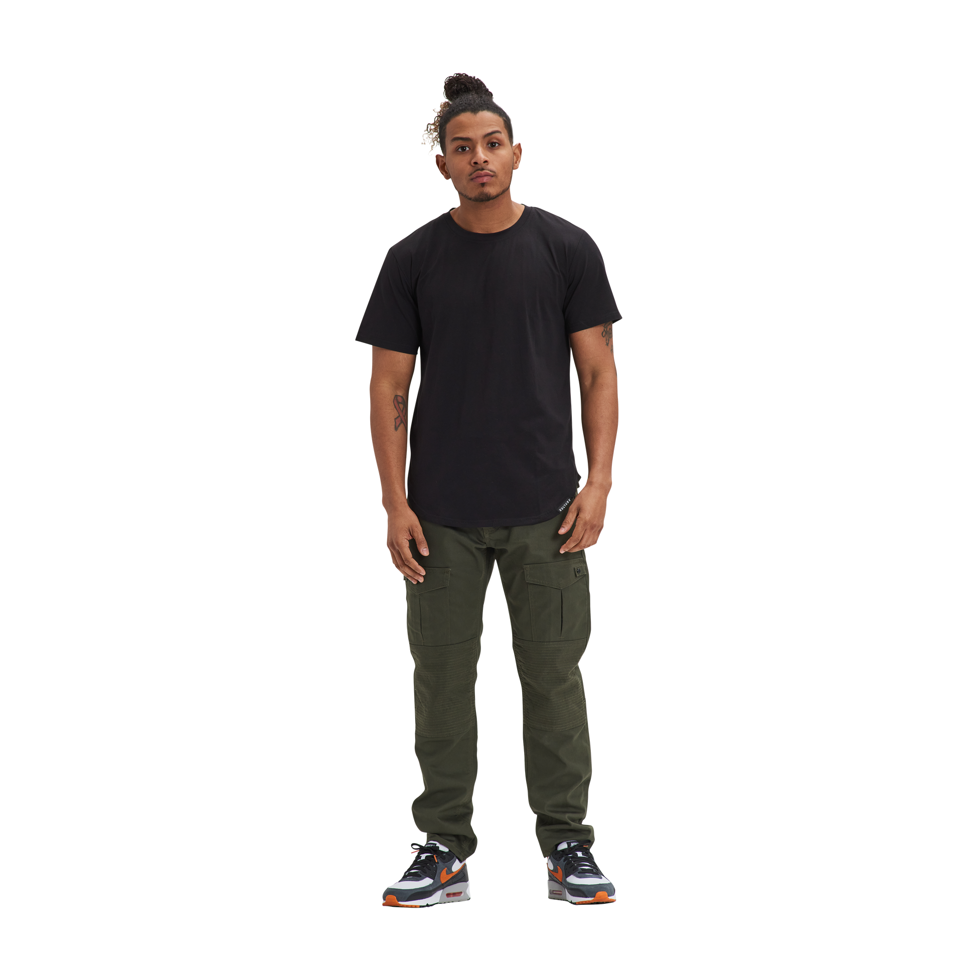 A man standing in front of a white background wearing a Kulture LAS Black Scoop Tee.