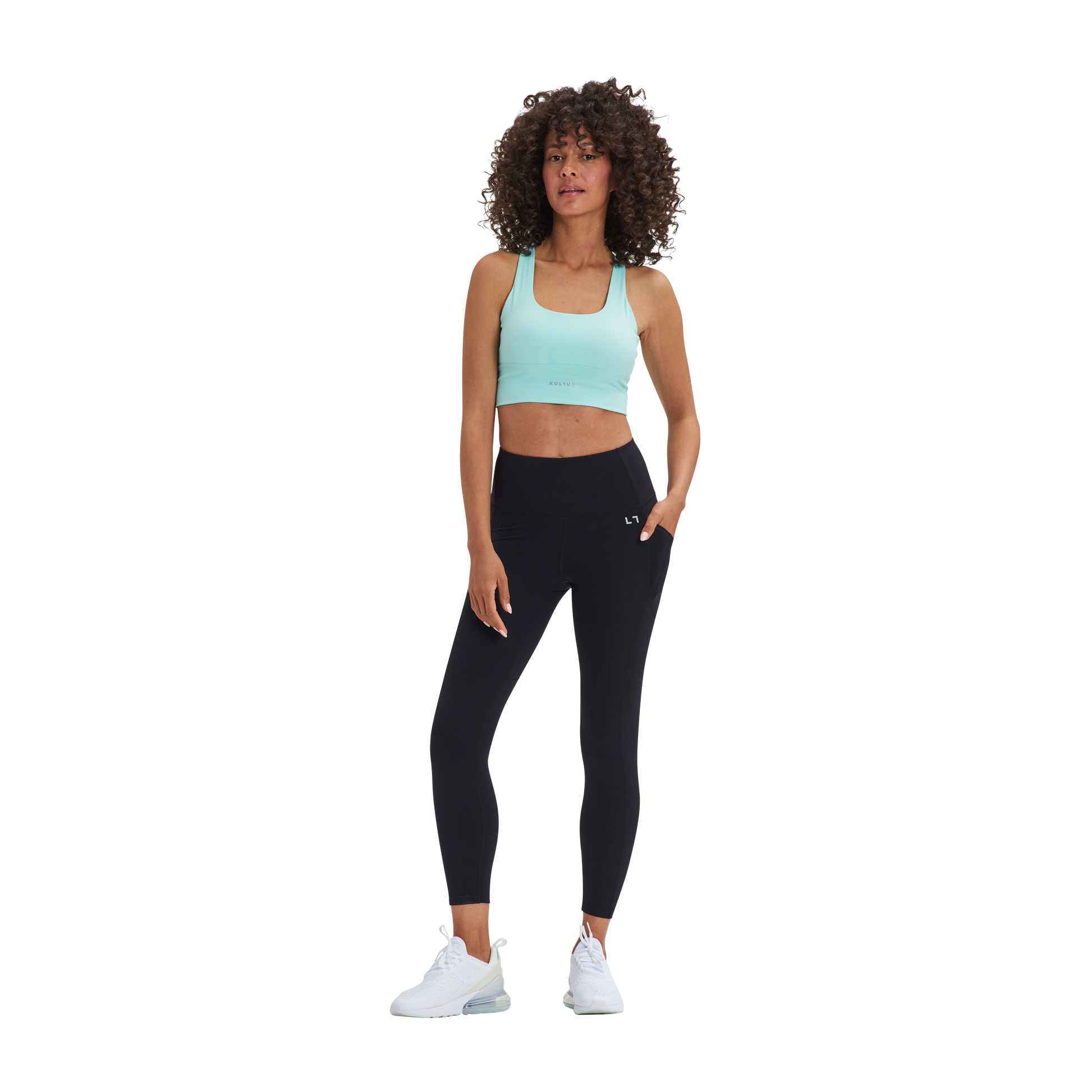 A woman in a Kulture Chelsea Leggings with Pockets and sports bra top.