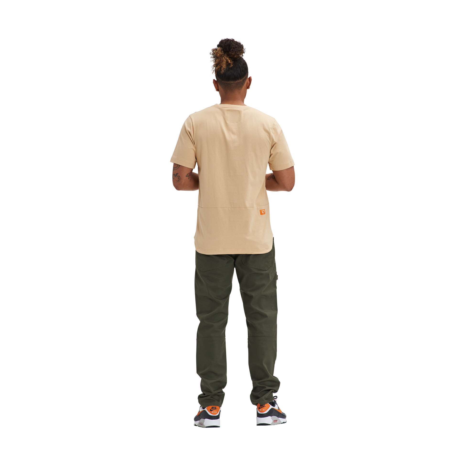 The back view of a man wearing a Kulture MIA Drop Cut Tee (3) PK White / Sand / Mint and green pants.