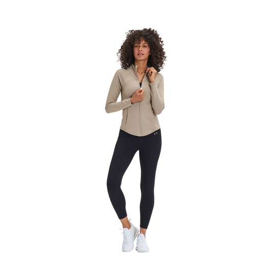 A woman in a Kulture Marina Sculpt Yoga Jacket with Pockets and black leggings.