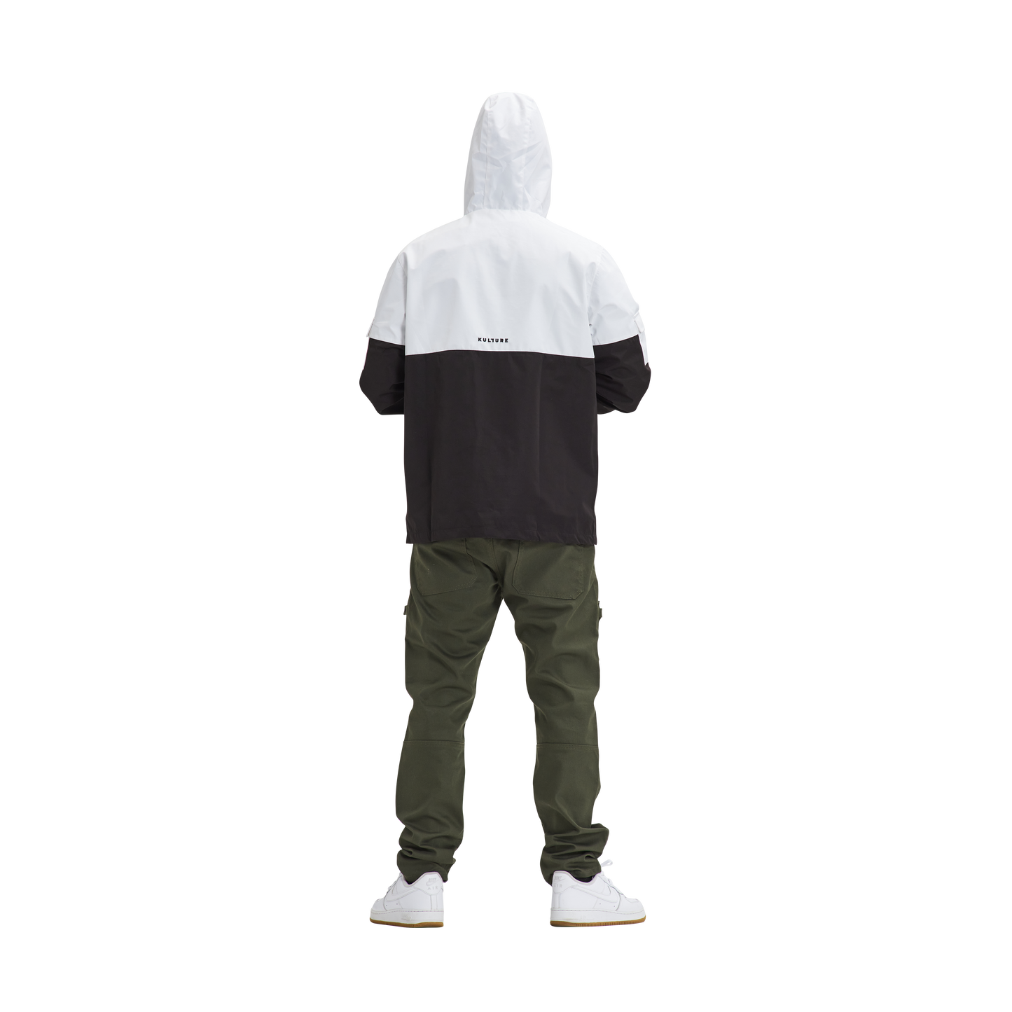 A man wearing a Kulture LAX V1 Hooded Anorak jacket in white and black and green pants.