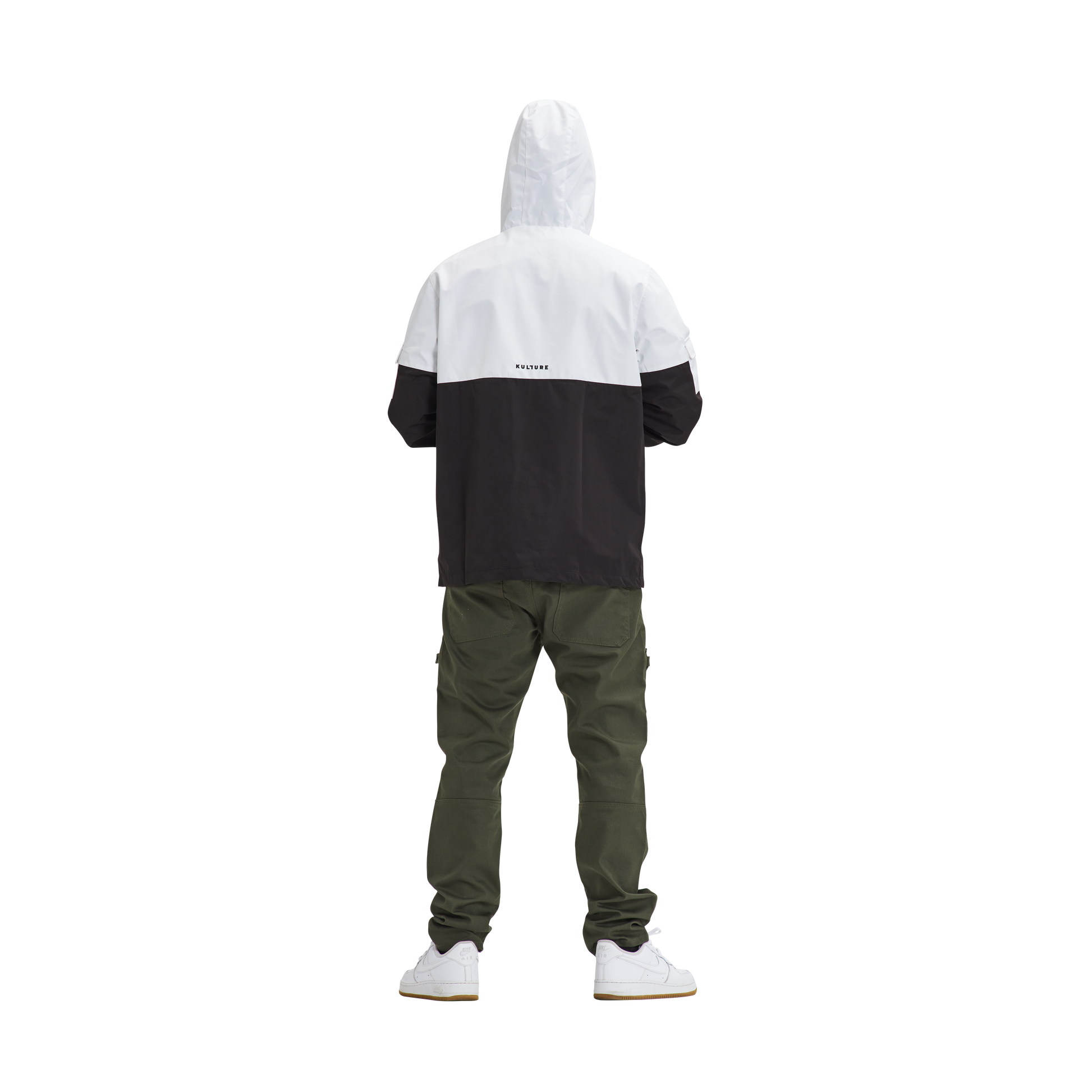 A man wearing a Kulture LAX V1 Hooded Anorak jacket in white and black and green pants.