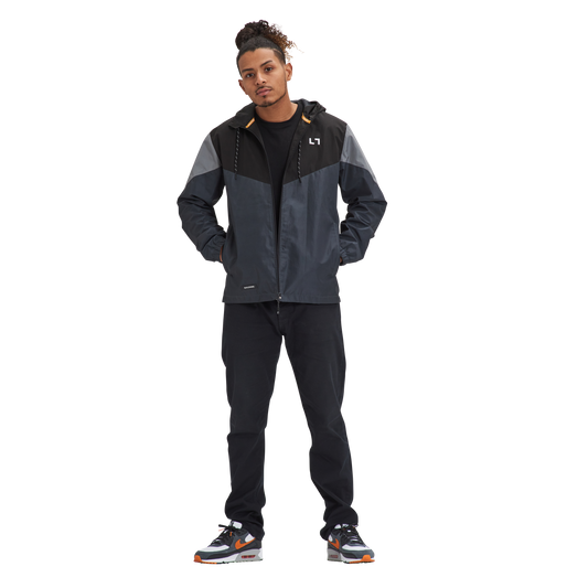 A man standing in front of a white background wearing the Kulture PDX V1 Hooded Shell Jacket Wind / Rain Repellent.