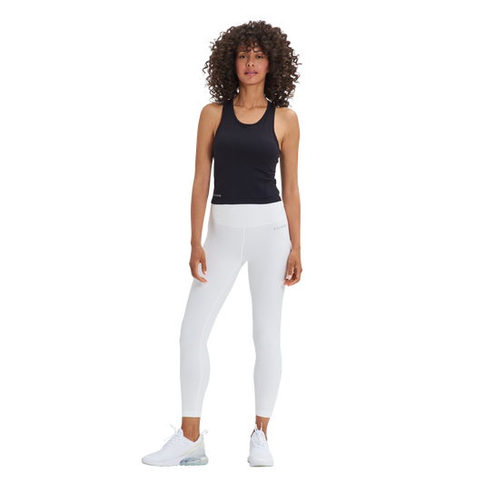 A woman wearing white pants and a Kulture Noho Seamless Built-In Bra Tank Top.