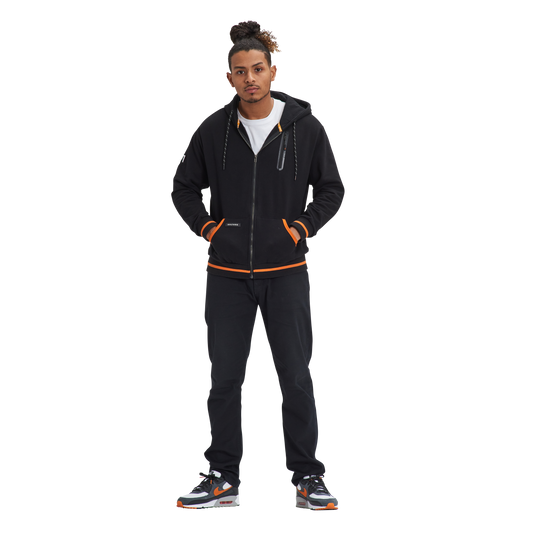 A man standing in front of a white background wearing the Kulture SFO V1 Full-Zip Hoodie.