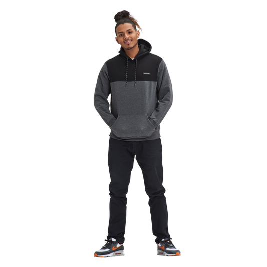 A man standing in front of a white background wearing the Kulture OAK V1 Fleece Hoodie.