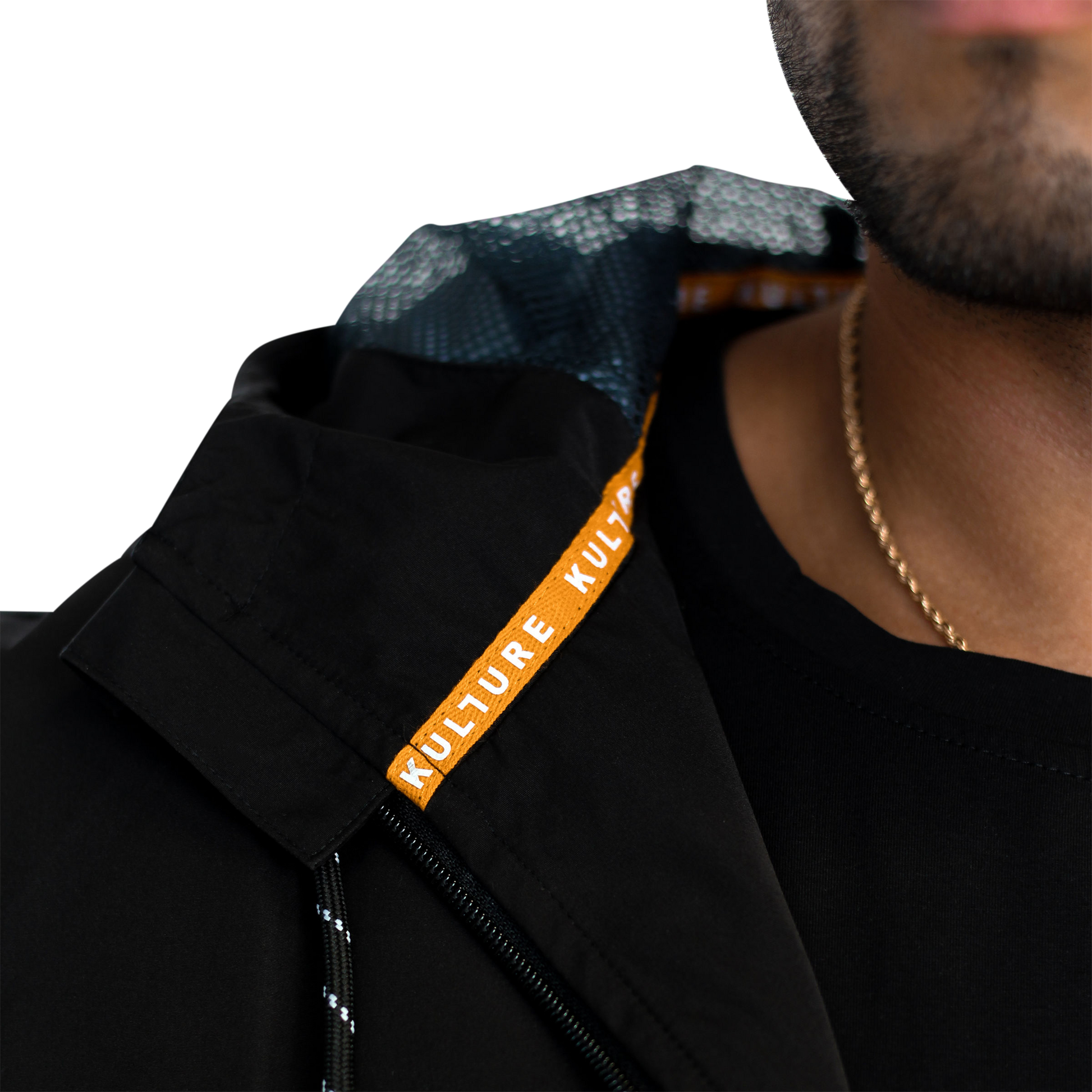 A close up of a man wearing a Kulture PDX V1 Hooded Shell Jacket Wind/Rain Repellent.